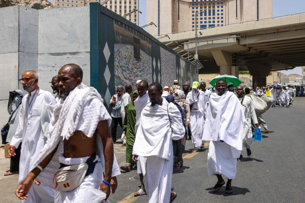 Muslim worshippers walk on the streets in the holy city of Mecca. — AFP