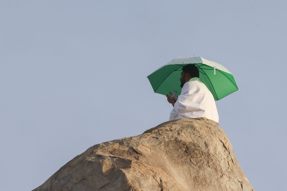 A Muslim pilgrim makes dua atop Saudi Arabia's Mount Arafat, also known as Jabal Al Rahma or Mount of Mercy, during the climax of the Haj pilgrimage. — AFP