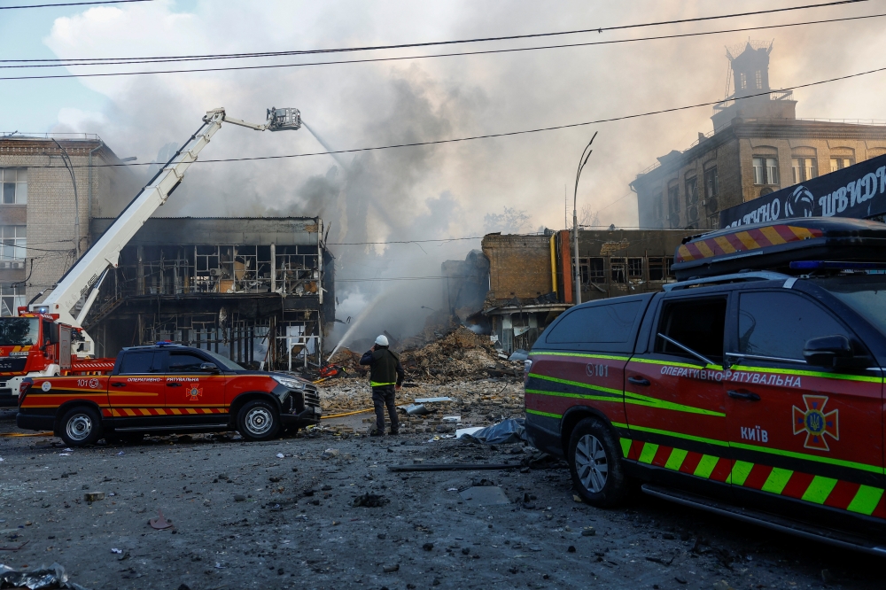 Firefighters work at the site of a Russian drone and missile strike, amidst Russia's attack on Ukraine, in Kyiv, Ukraine on Friday. — Reuters