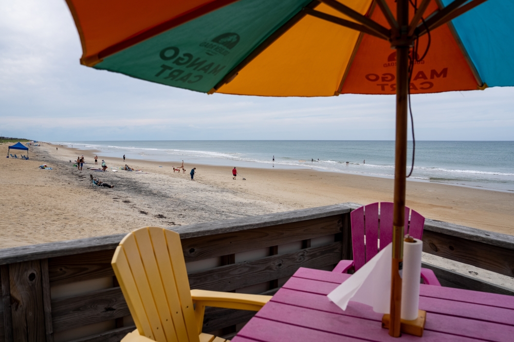 Seating at a restaurant at the Nags Head Fishing Pier in Nags Head, N C. — The New York Times