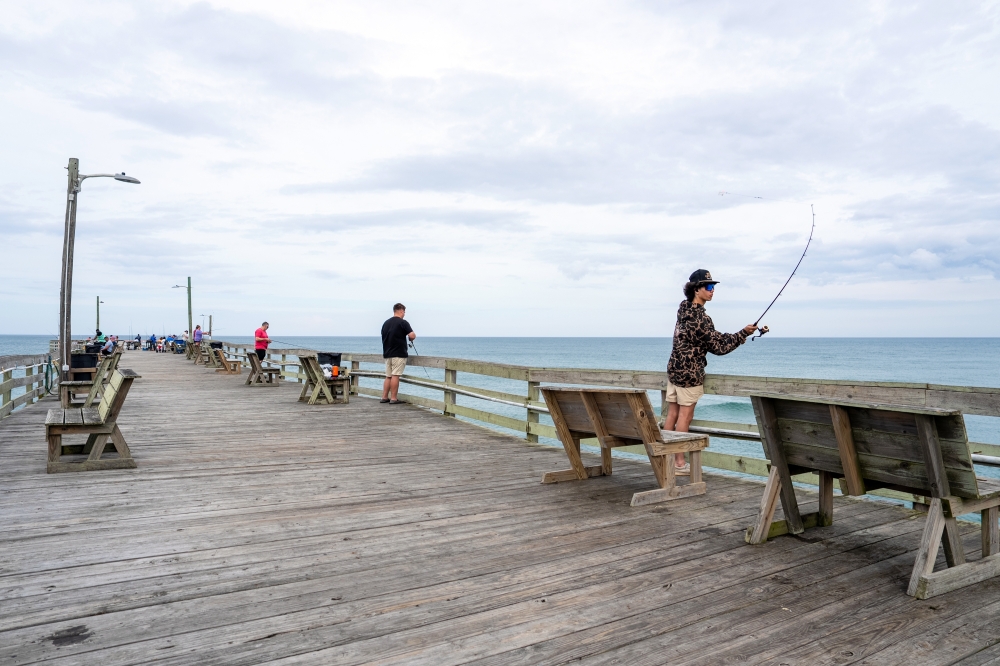Anglers at the fishing pier in Nags Head, N C. — The New York Times