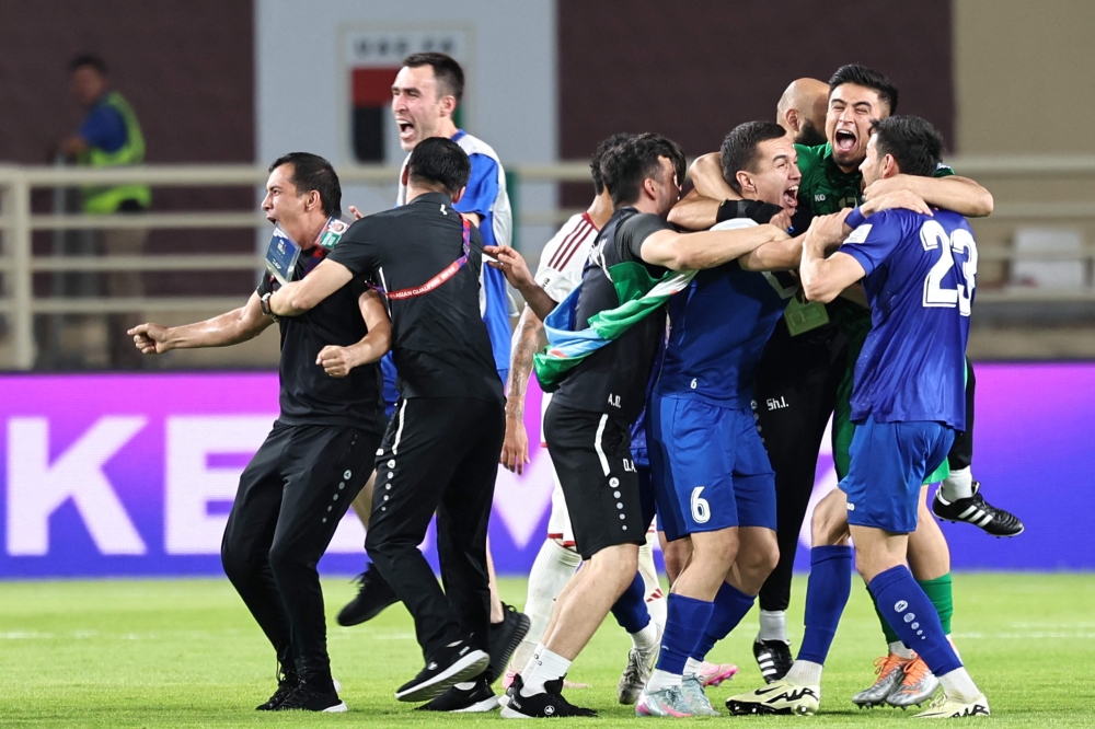 Uzbekistan's players celebrate after the qualifier. — AFP