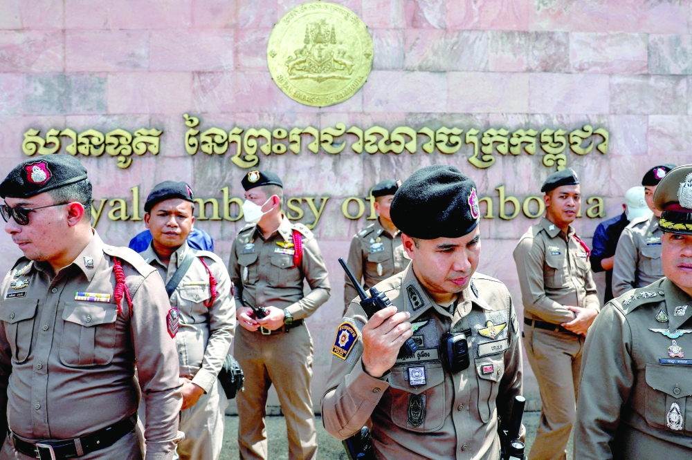 Police officers stand guard in front of the Royal Embassy of Cambodia, in Bangkok. — Reuters file photo