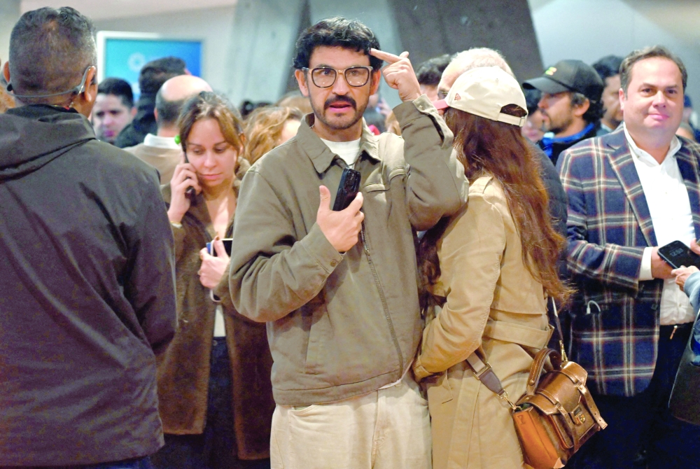 Relatives and friends of Senator Uribe wait to receive news about his health, in Bogota. — AFP