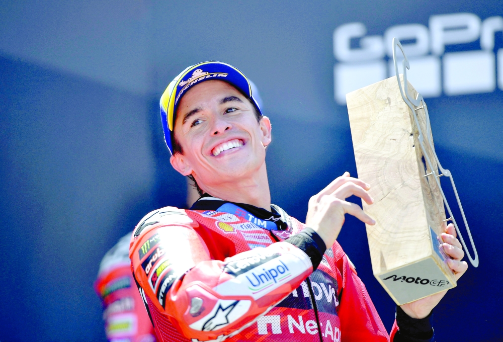Marc Marquez celebrates with the trophy. — Reuters