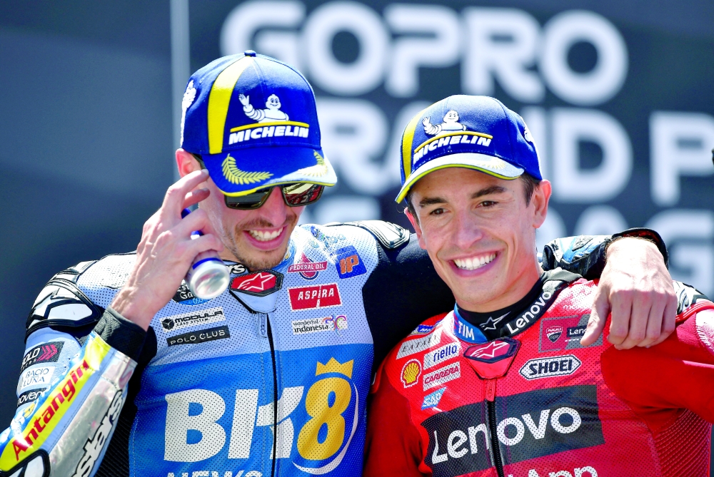 Marc Marquez (R) celebrates alongside 2nd place Alex Marquez. — Reuters