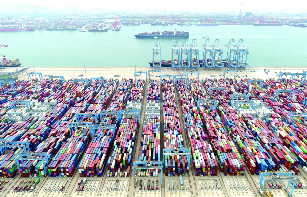 An aerial view shows containers and cargo vessels at the Qingdao port in Shandong province, China. — Reuters