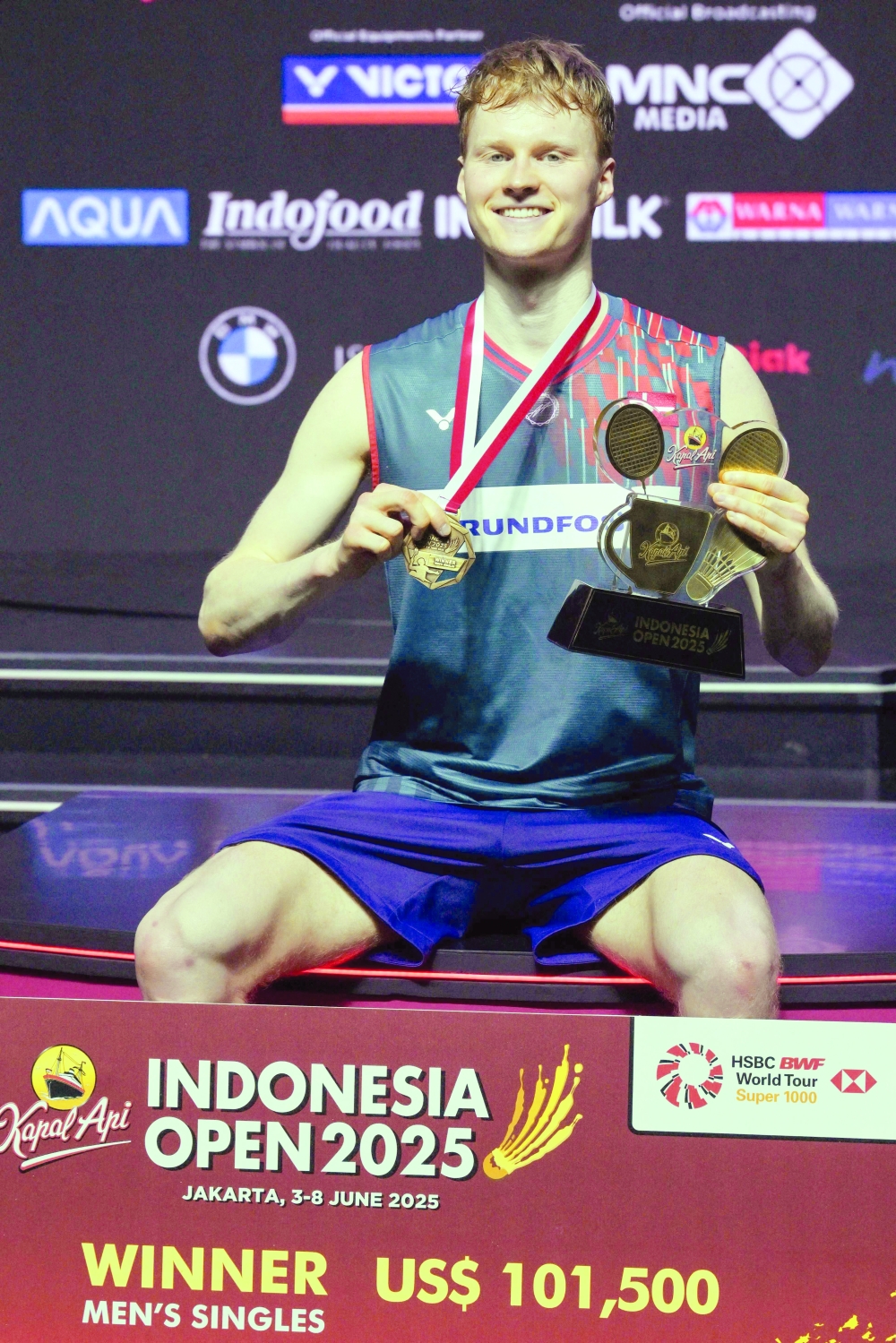Denmark's Anders Antonsen celebrates on the podium. — Reuters