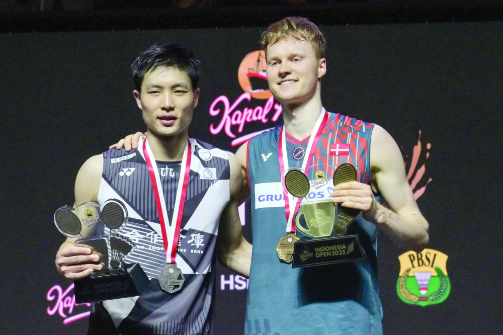 Denmark's  Anders Antonsen (R) poses on the podium with runner-up Taiwan's Chou Tien-chen. — Reuters