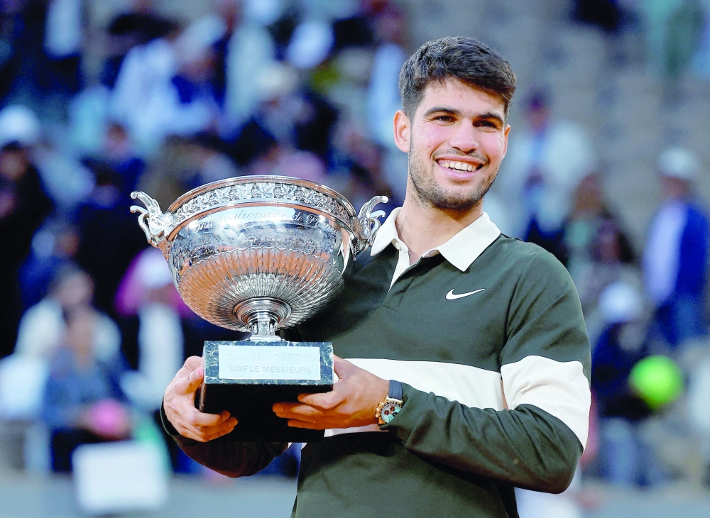 Carlos Alcaraz celebrates with the trophy. — Reuters