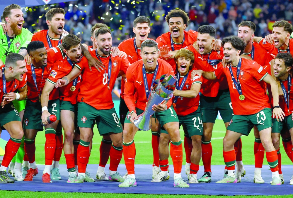 Portugal's Cristiano Ronaldo lifts the trophy as he celebrates with teammates. — Reuters
