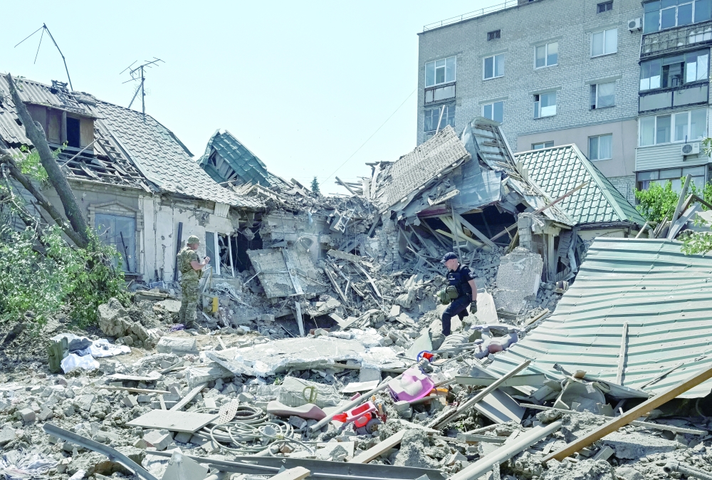 Police experts work at the site of the Russian air strike, amid Russia's attack on Ukraine, in Zaporizhzhia. — Reuters