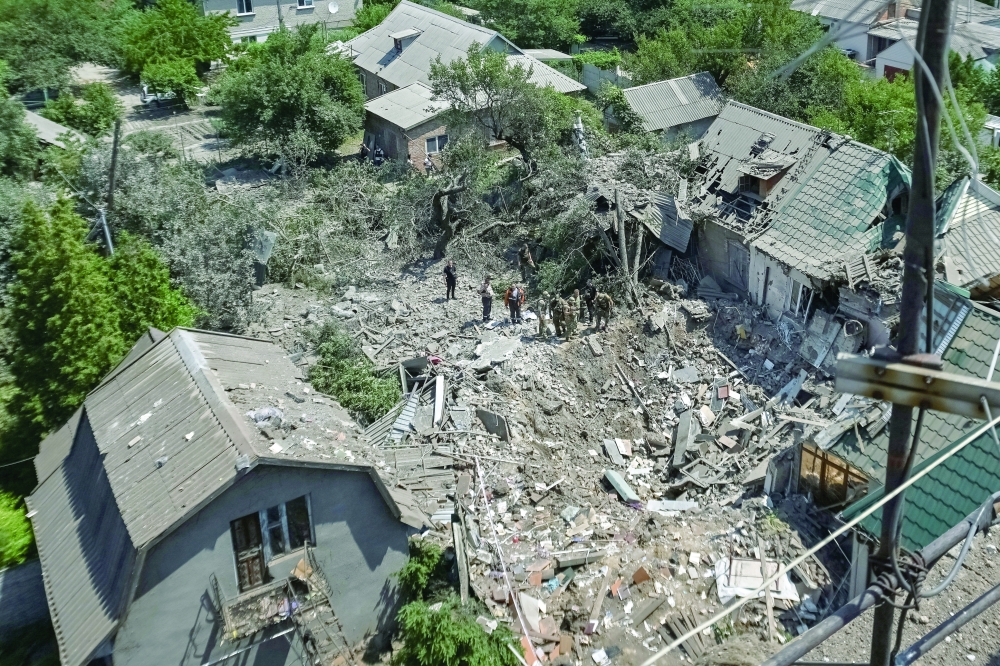 Police experts work at the site of the Russian air strike, amid Russia's attack on Ukraine, in Zaporizhzhia. — Reuters