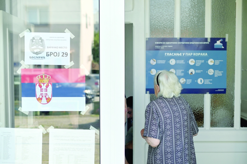 A woman enters a polling station during the local elections in Kosjeric town. — AFP