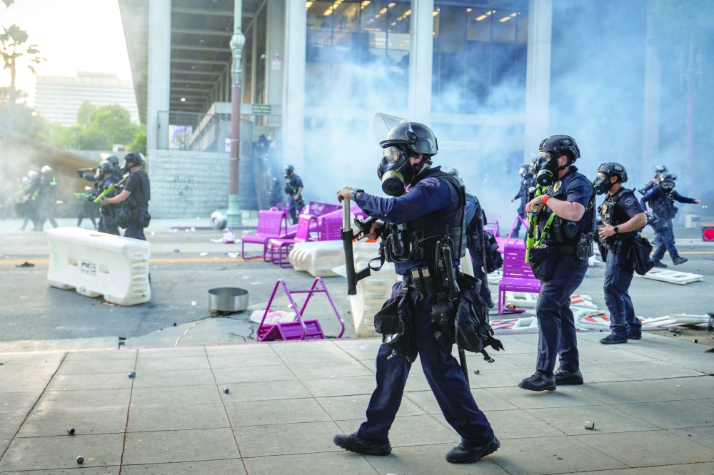 Los Angeles Police Department (LAPD) officers move in on demonstrators in front of LA City Hall. — Reuters
