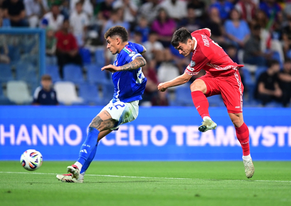 Italy's Giovanni Di Lorenzo in action with Moldova's Ion Nicolaescu. — Reuters