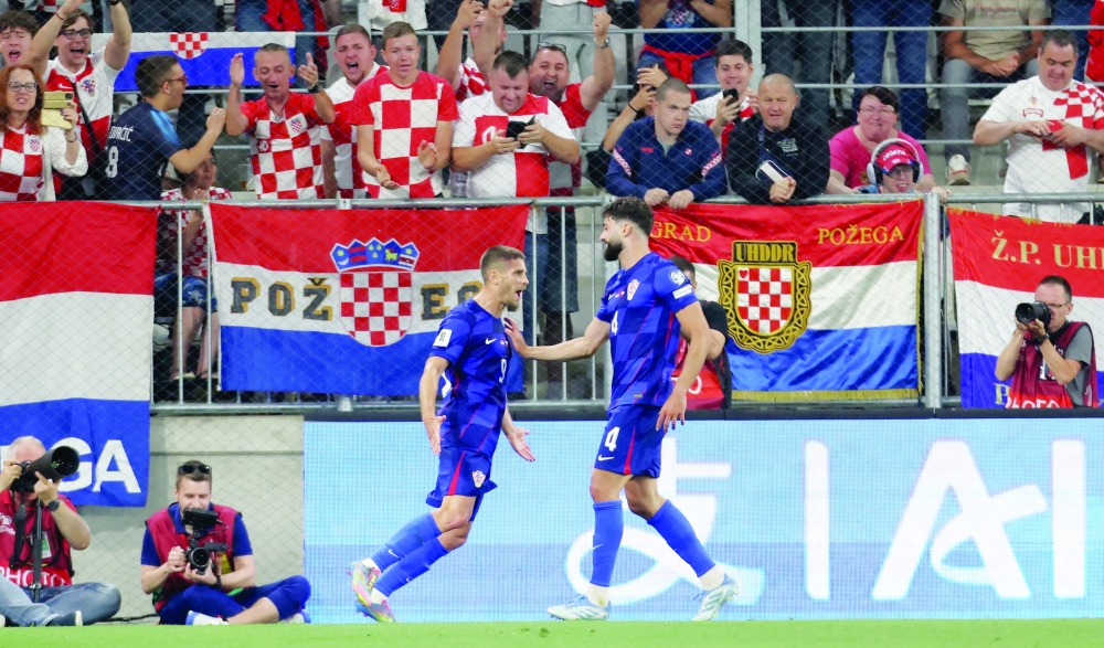 Croatia's Andrej Kramaric celebrates scoring their first goal with Josko Gvardiol. — Reuters