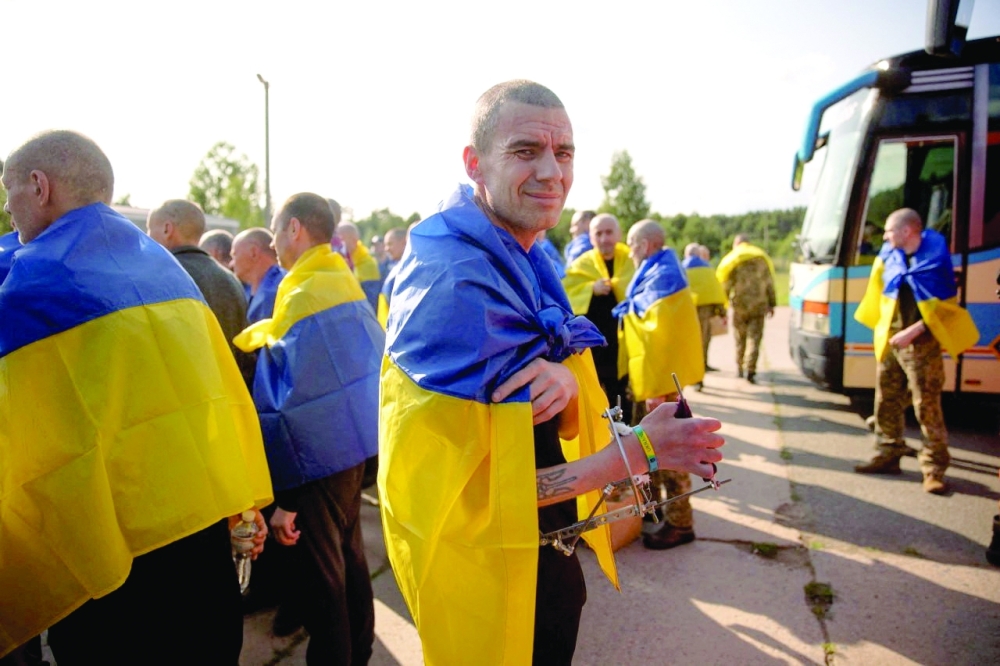 A Ukrainian prisoner of war (POWs) looks on as he stands witgh others after a swap. — Reuters