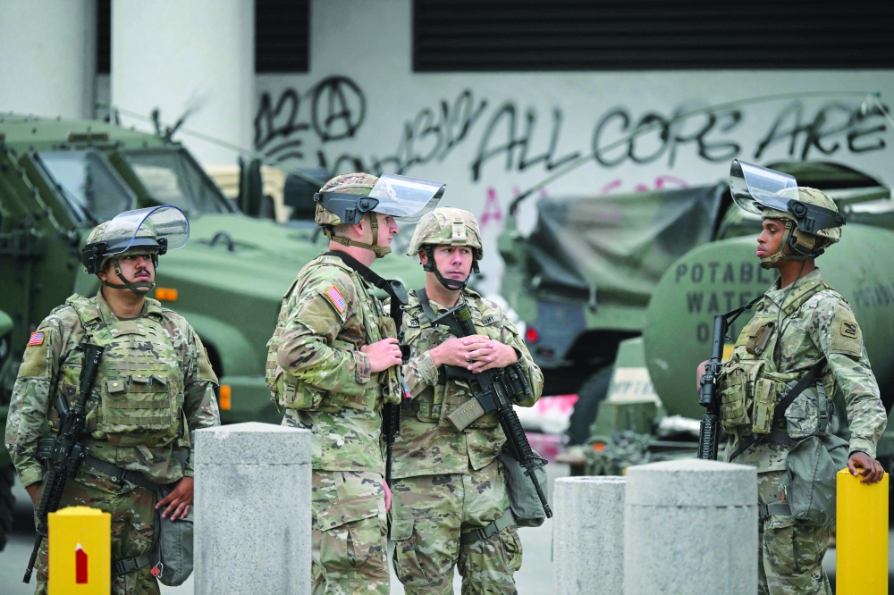 Members of the California National Guard stand watch outside the Edward R Roybal Federal Building. — AFP