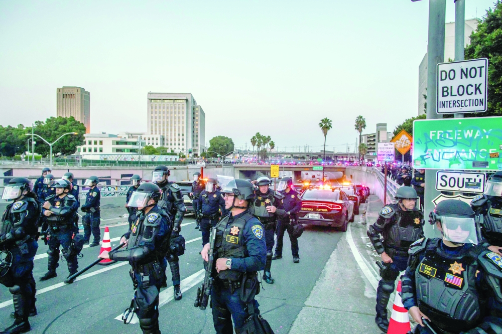 California Highway Patrol (CHP) close the bridges and the access to the Freeway after curfew, in Los Angeles. — AFP