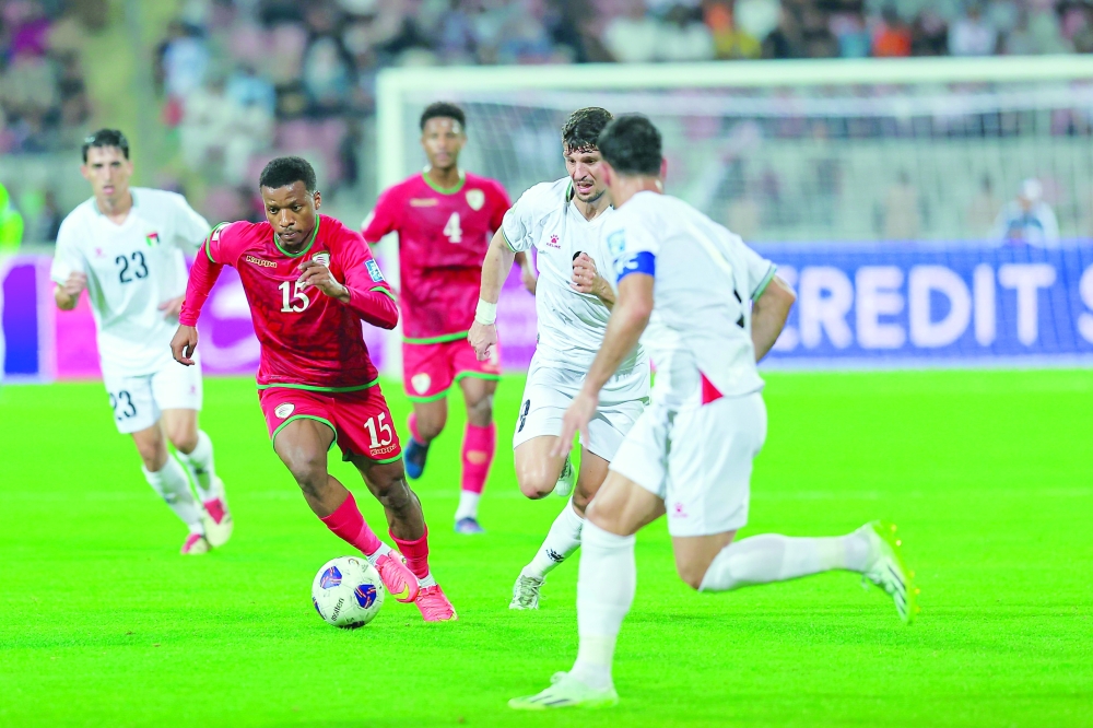 Oman player controls the ball