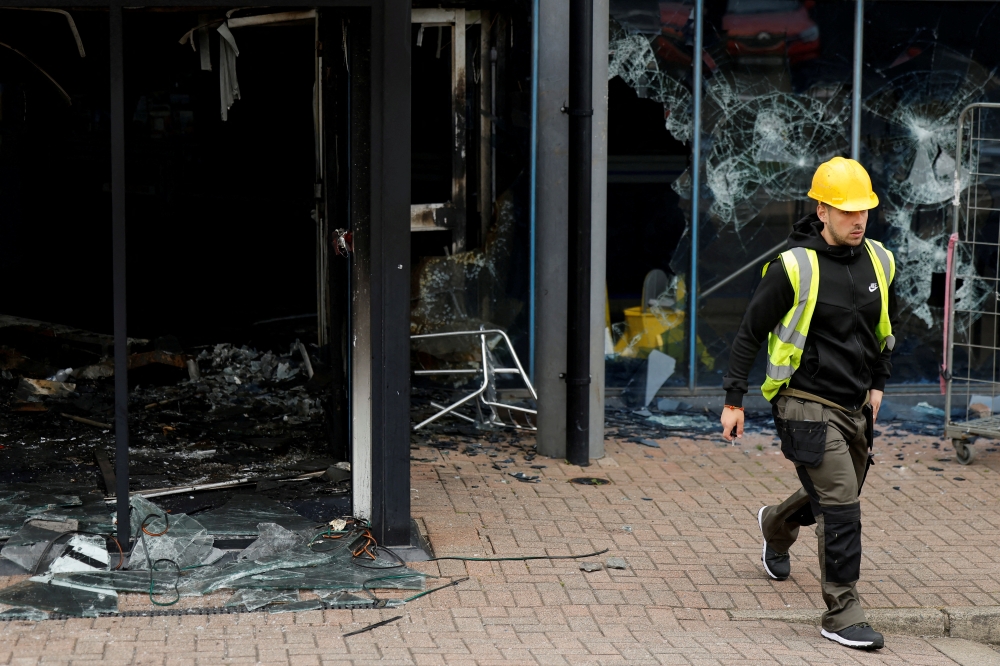 A municipal worker walks next to Larne Leisure Centre which, in Ballymena. — Reuters