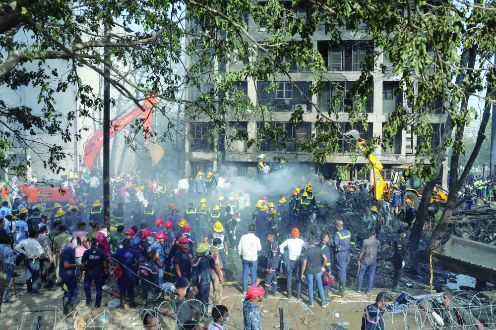 Rescue team members work at the site where an Air India Boeing 787 Dreamliner plane crashed. — Reuters