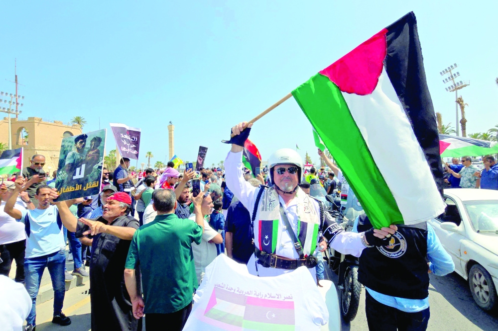 Activists, heading towards Gaza by land with the aim of breaking the siege on the Palestinian territory, are greeted by Libyans in Tripoli's Martyrs Square. — AFP