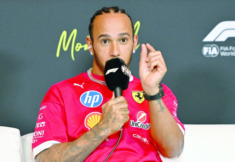 Ferrari's Hamilton talks to press. — Reuters