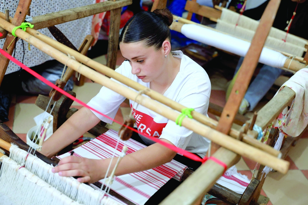 Rozana Gostorani works at the loom in a small workshop in the village of Dajc, in the Zadrima region, about 80 km from Tirana. — AFP