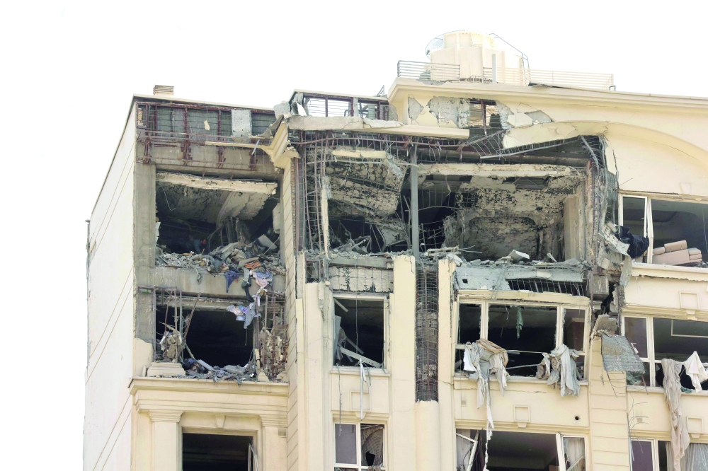 This picture shows a building damaged in an Israeli strike on Tehran on Friday. Israel hit about 100 targets in Iran including nuclear facilities and military command centres and killied senior figures including the armed forces chief and top nuclear scientists. — AFP