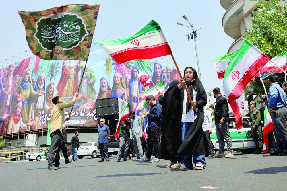 People attend an anti-Israeli protest following the Israeli strikes on Iran, in Tehran, on Friday. — Reuters
