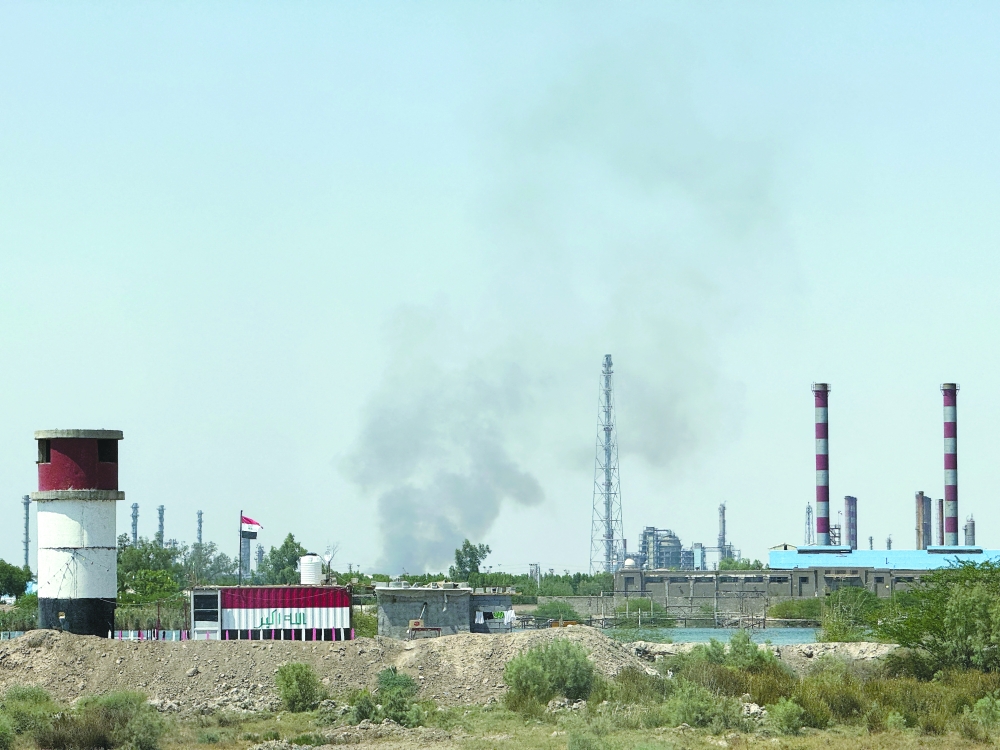 Smoke rises near Iran's Abadan refinery, as seen from Al Siba district on the Iraqi side of the border in Basra. — AFP