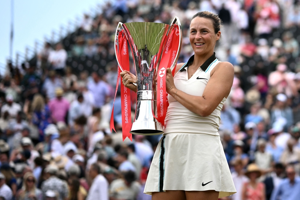 Tatjana Maria poses with the trophy in west London on Sunday. — AFP