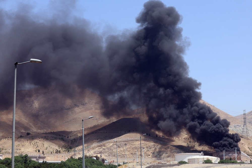 Smoke billows for the second day from the Shahran oil depot, northwest of Tehran. — AFP