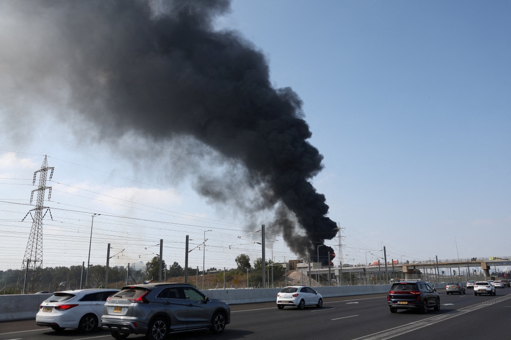 Smoke rises after Iran's missile attack in Herzliya, Israel, on Tuesday. —  Reuters