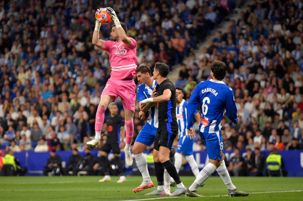 (FILES) Espanyol's Spanish goalkeeper #01 Joan Garcia catches the ball during the Spanish league football match between RCD Espanyol and FC Barcelona at the RCDE Stadium in Cornella de Llobregat, on May 15, 2025. Barcelona announced on June 18, 2025 they had signed Espanyol goalkeeper Joan Garcia for 26.34 million euros ($31 million) on a six-year deal. (Photo by MANAURE QUINTERO / AFP)