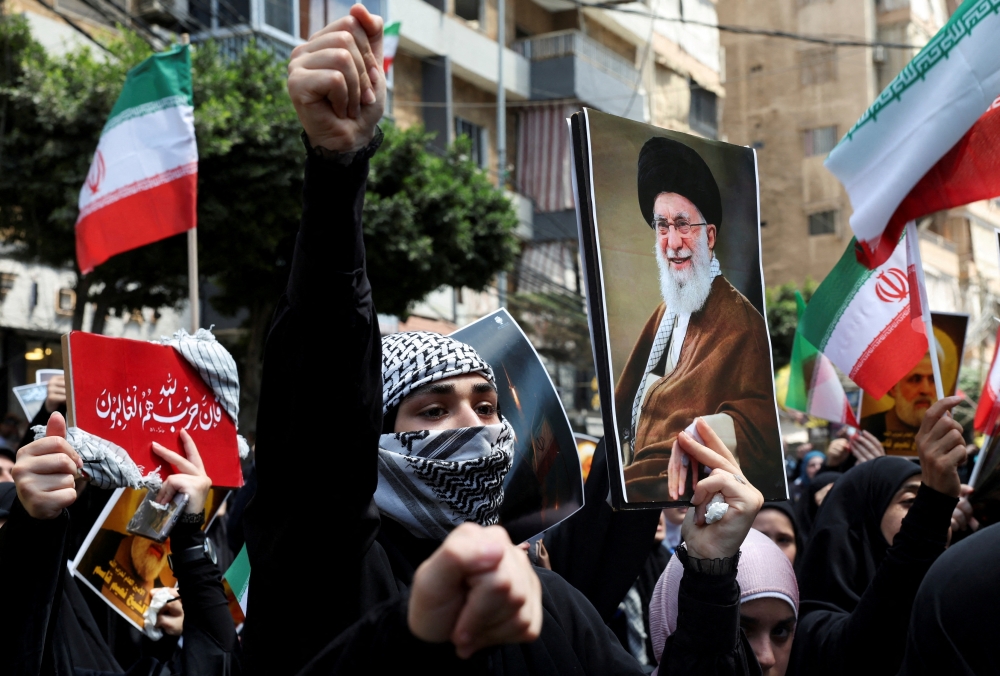 A demonstrator holds a picture of Iran's Supreme Leader Ayatollah Ali Khamenei as people gather for a rally in solidarity with Iran after Friday prayers in Beirut's southern suburbs, Lebanon. — Reuters