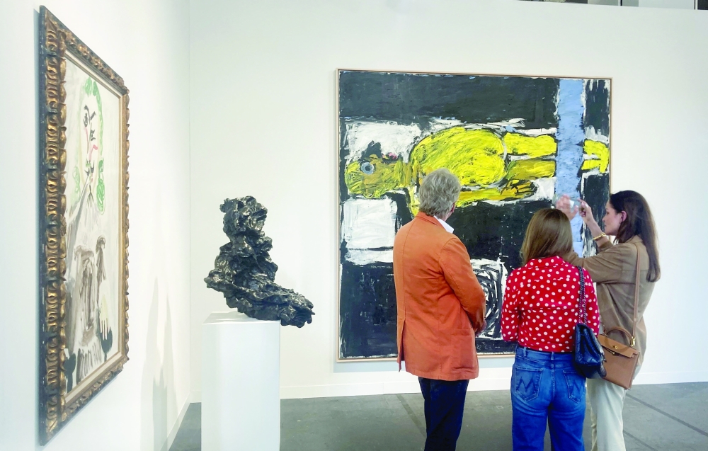 Visitors look at an artwork displayed at Art Basel, in Basel, Switzerland, June 17, 2025. 