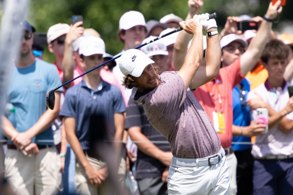 Tommy Fleetwood plays his shot from the first tee during the third round of the Travelers Championship golf tournament. 
