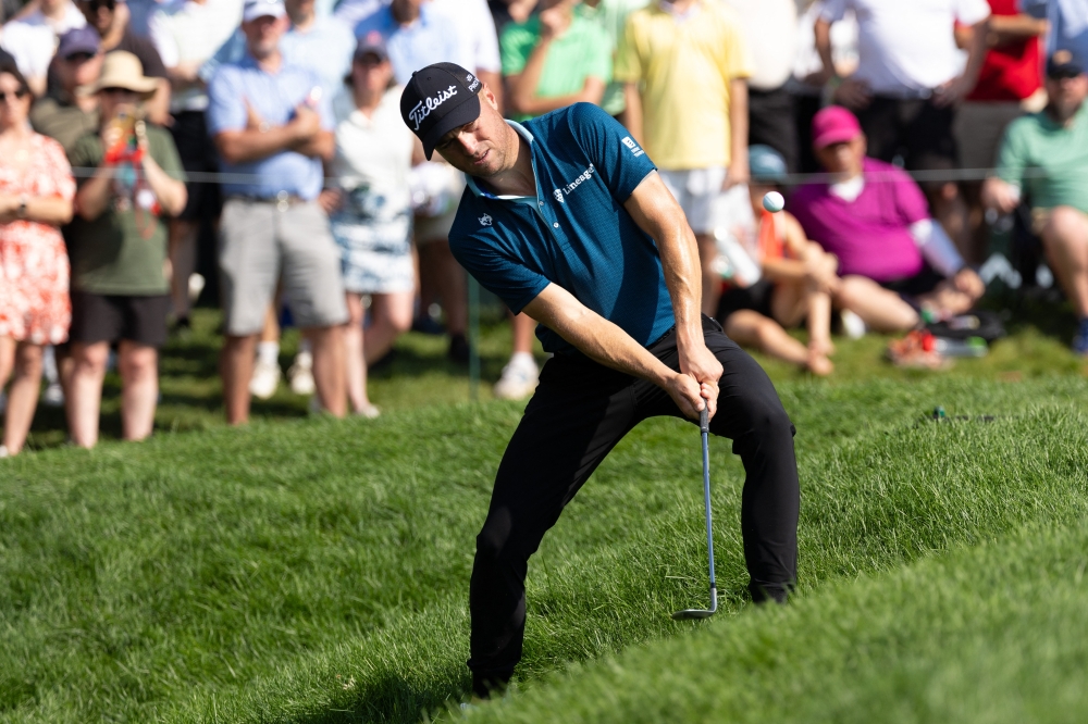 Justin Thomas chips out of the rough on the ninth hole during the third round of the Travelers Championship golf tournament. 