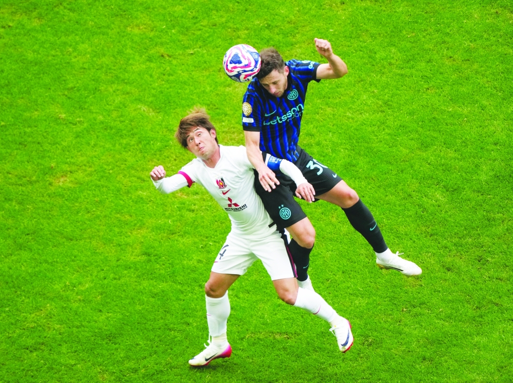Urawa Red Diamonds' Yusuke Matsuo in action with Inter Milan's Matteo Darmian. — Reuters 