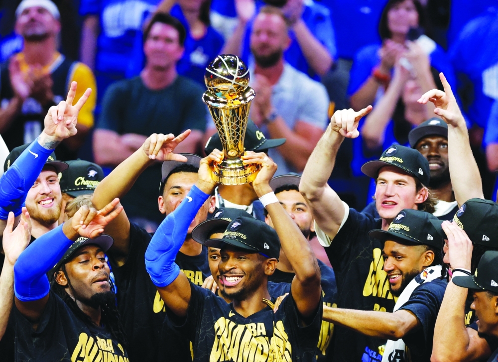 Oklahoma City Thunder guard Shai Gilgeous-Alexander (2) lifts the Larry O'Brien Championship Trophy. — Reuters