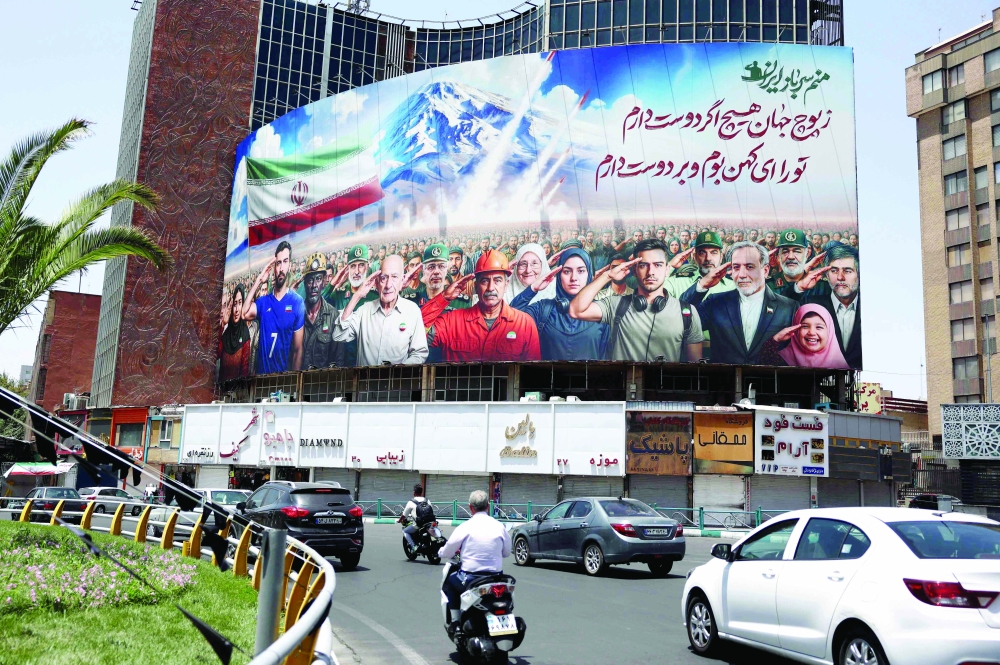 A banner bearing a painting that represents various categories of the Iranian society, in Tehran. — AFP