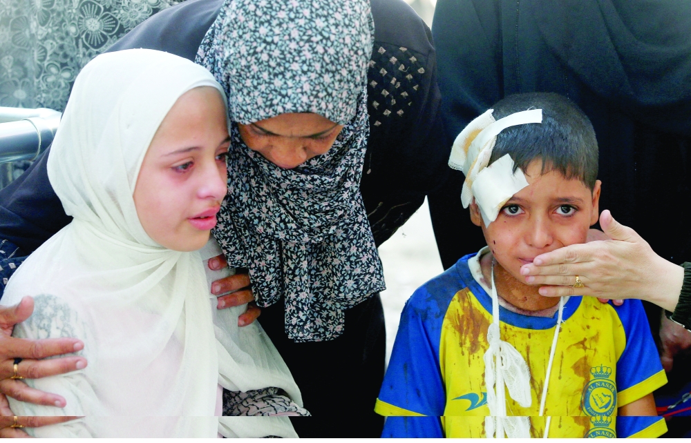 An injured boy and other mourners react during the funeral of Palestinians, in Gaza. — Reuters
