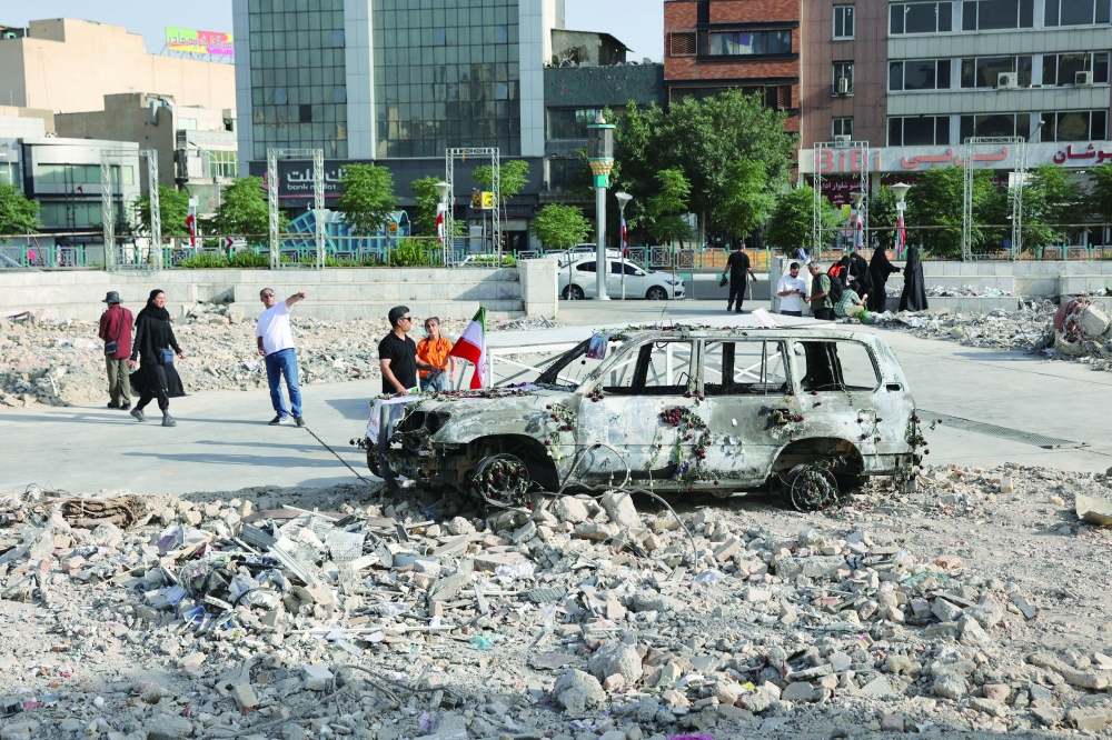 An ambulance burned by Israeli attacks stands on a street, in Tehran. — Reuters