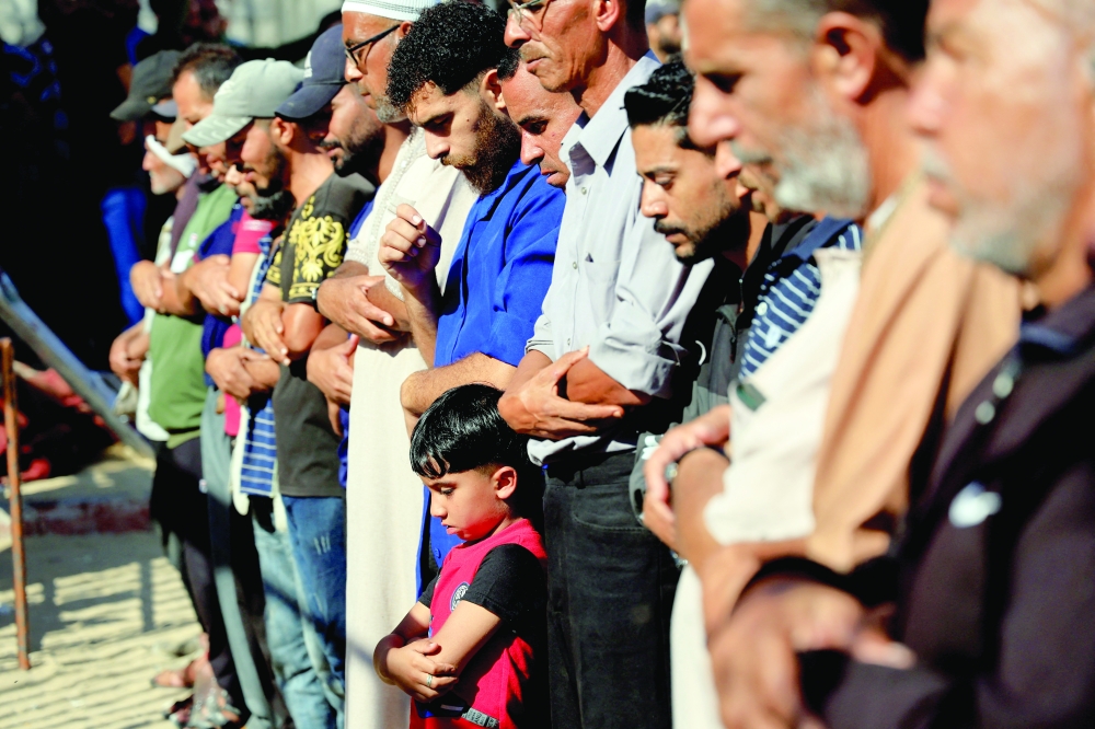 Mourners pray as they attend the funeral of Palestinians killed at Nasser hospital in Khan Yunis, southern Gaza Strip. - Reuters