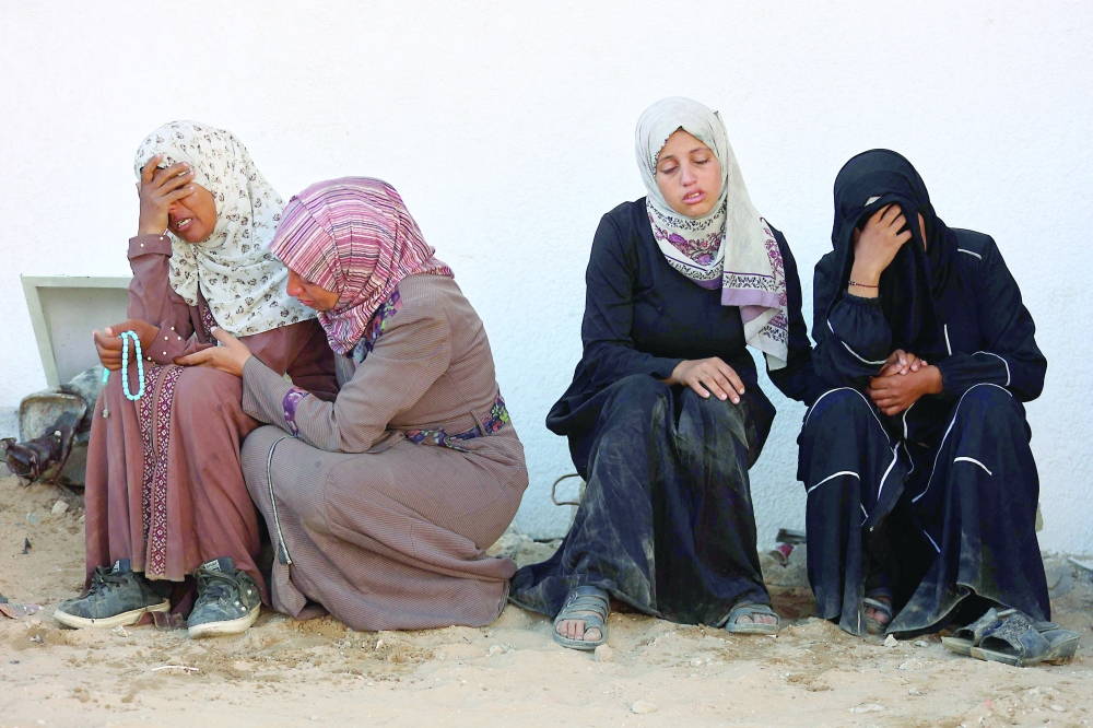 Palestinian women mourn the death of loved ones outside the morgue of Al Shifa Hospital in Gaza City amid the ongoing conflict between Israel and Hamas. - AFP