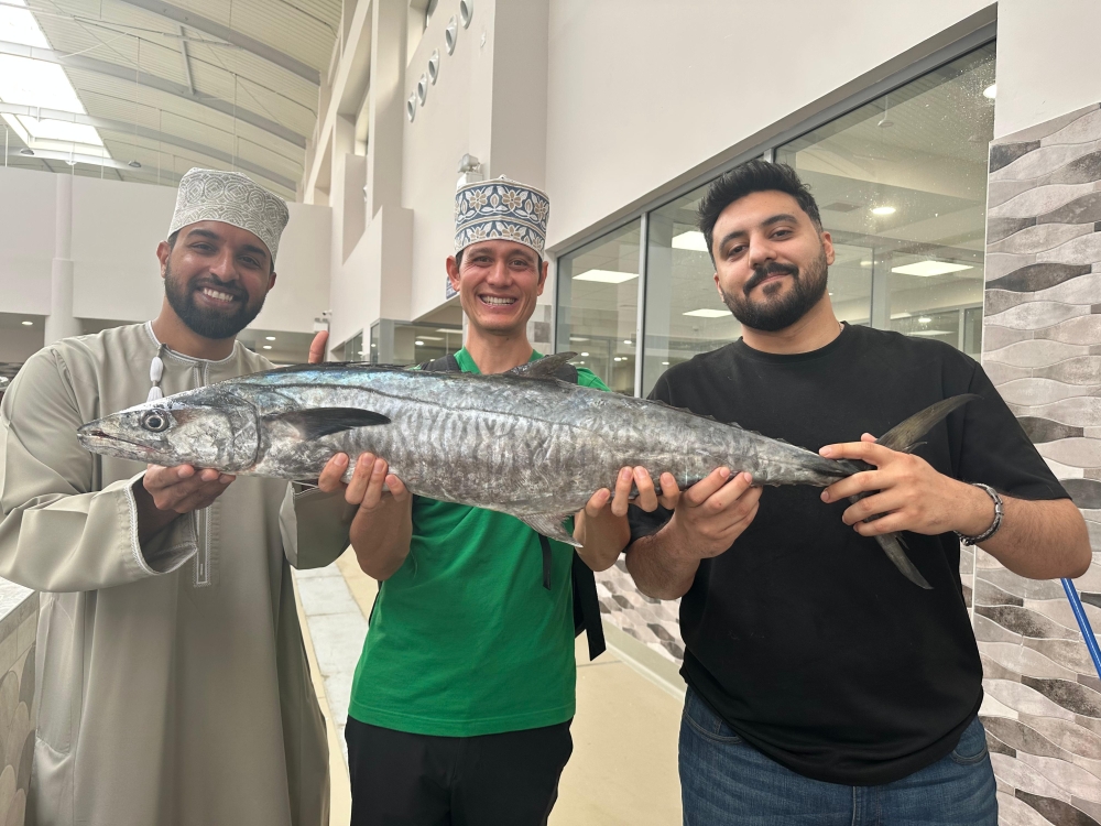 Global food blogger Mark Wiens and Ahmed al Lawati with freshly caught kingfish at Muttrah fish market