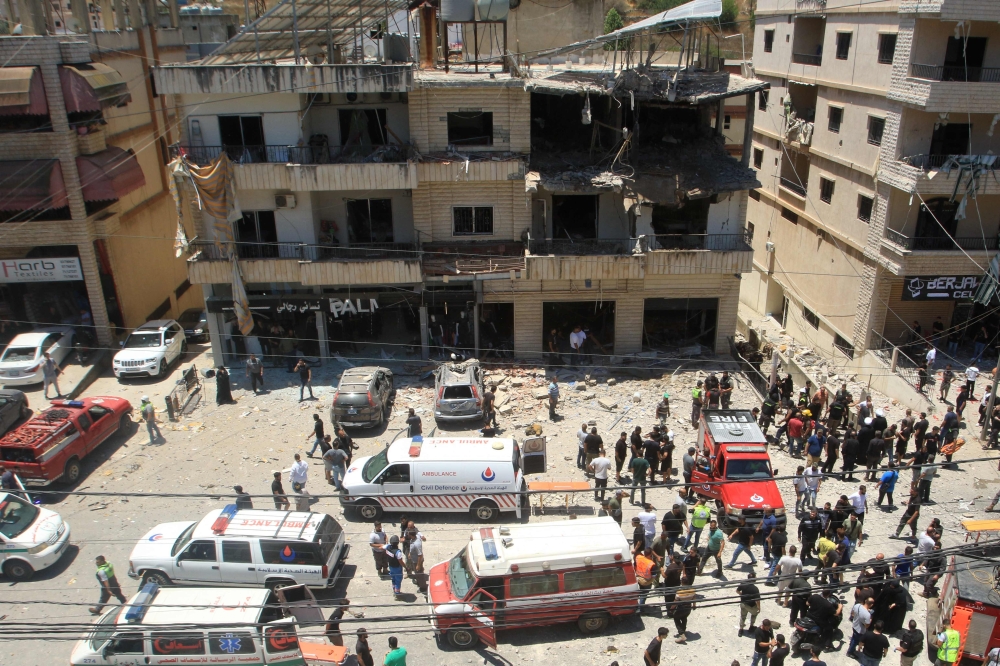 People inspect the damage after an Israeli strike on Nabatieh in southern Lebanon. — AFP